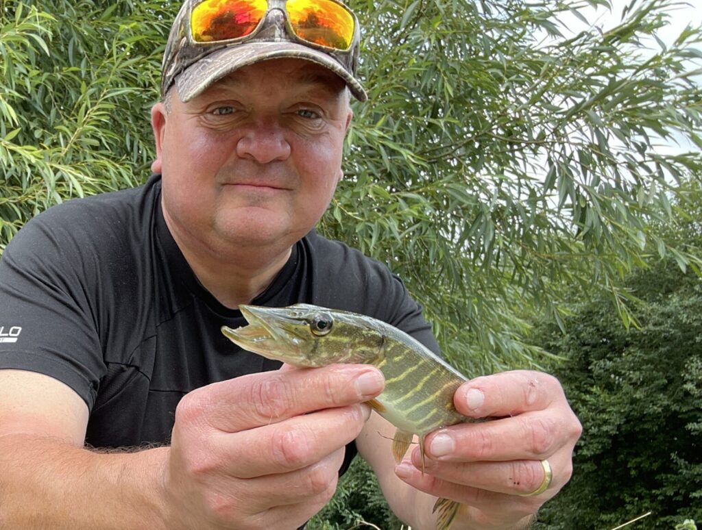 Kevin Stack Fishing Maverick with a tiny Pike fish